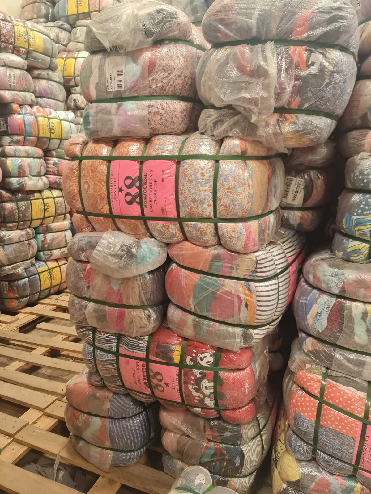 Clothing bales stacked on pallets in the stockroom